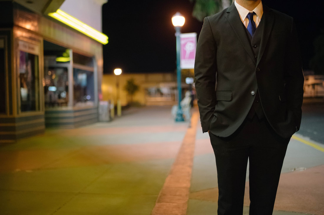 man in suit with blue tie