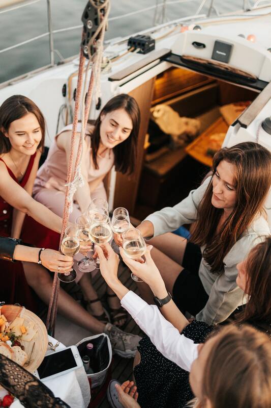 women drinking cheers on a boat