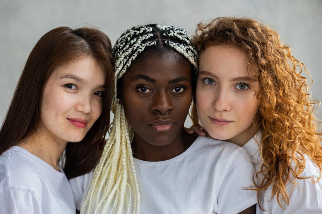 Three women smiling at camera