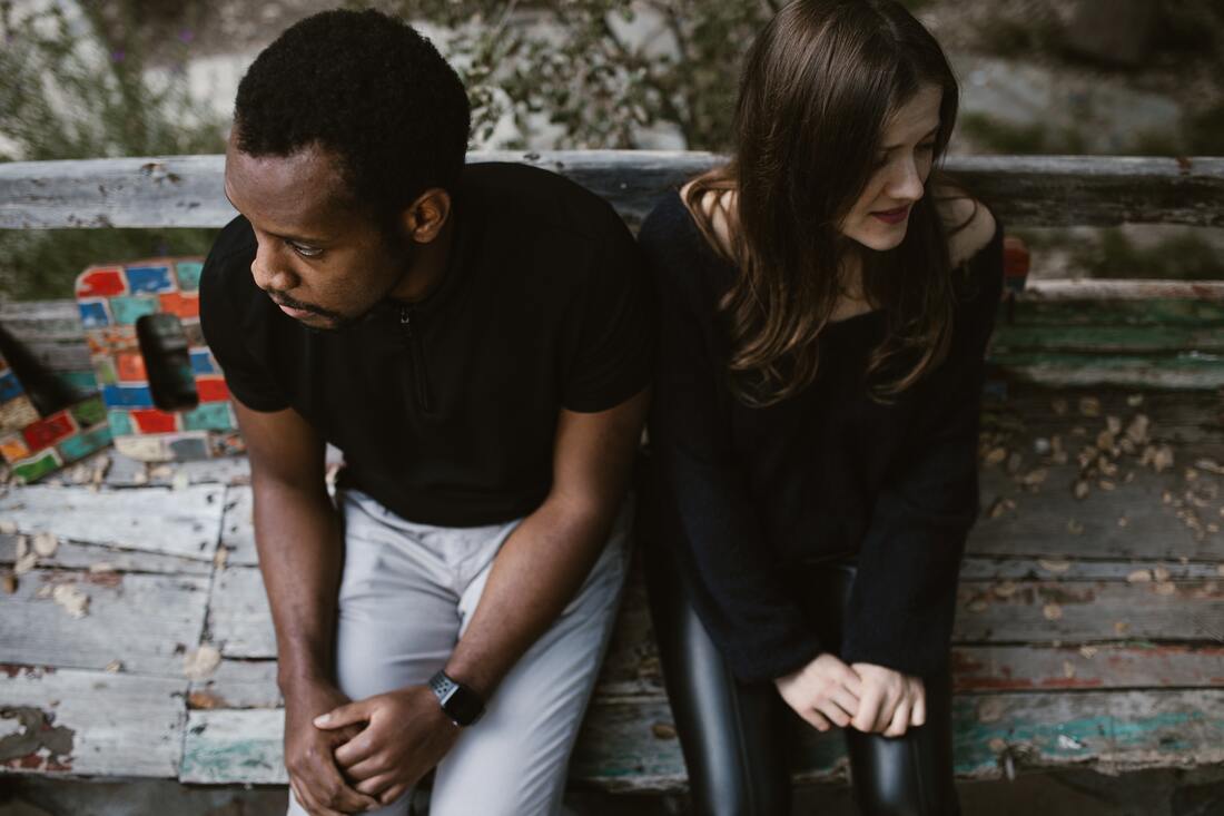 man woman facing away from each other