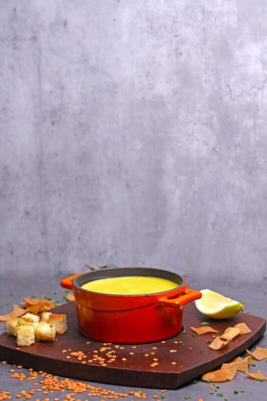 Red pot on wooden board