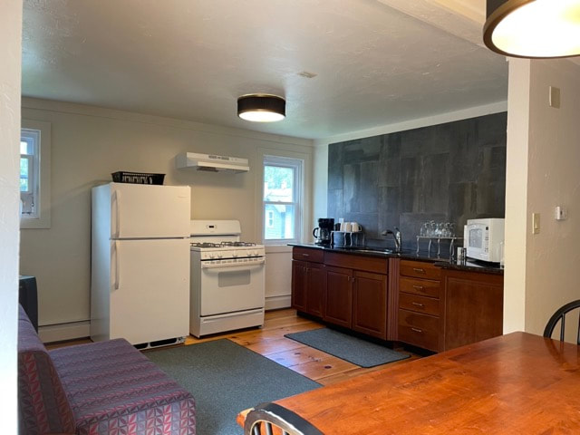 kitchen with stove, microwave, sink and dining  table