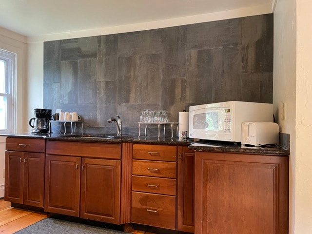 kitchen with stove, microwave, sink and dining  table