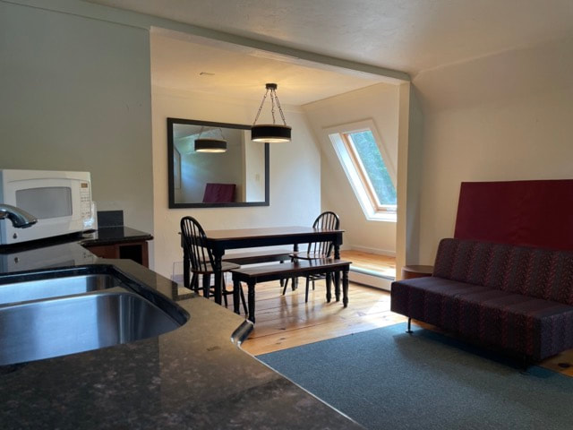 kitchen with stove, microwave, sink and dining  table