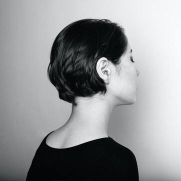 Black and white photo of the side profile of a woman with short black hair. Her eyes are closed. This represents that Sacred Circle Holistic Healing offers online counseling throughout Kansas for low self-esteem.