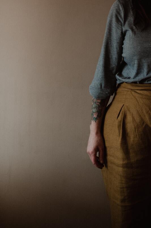 The right side of someone's body. They are wearing earth tones and and have a tattoo. This represents that Sacred Circle Holistic Healing provides counseling in Kansas to Highly Sensitive People.