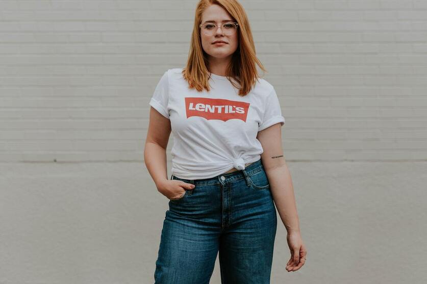 woman with red hair standing in jeans. This illustrates that Sacred Circle Holistic Healing offers counseling services to women with anxiety. 