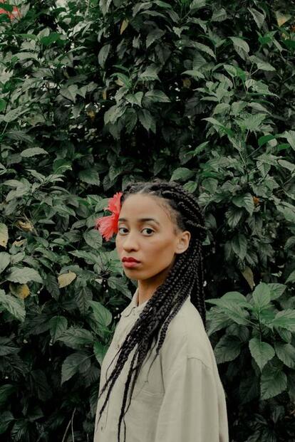 Black woman looking into camera with a serious expression on her face. This illustrates that Sacred Circle Holistic Healing provides therapy for woman who ares struggling with low self-esteem.