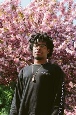 Young Black man looking into the camera. This represents the young adult highly sensitive clients Maggie Jones Boyle sees for therapy in Lawrence Kansas.