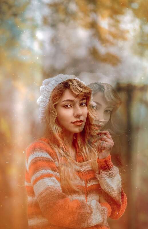Young woman looking at the camera in an orange striped sweater. This illustrates that Sacred Circle Holistic Healing offers virtual therapy in Lawrence, Kansas for adults healing childhood trauma.