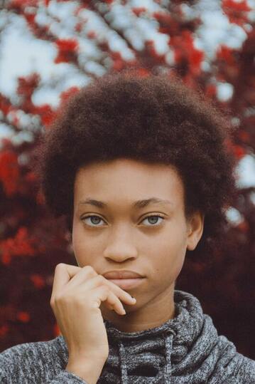 Young black woman looking into the camera. This illustrates that Sacred Circle Holistic Healing helps young women in Kansas learn to set healthy boundaries.