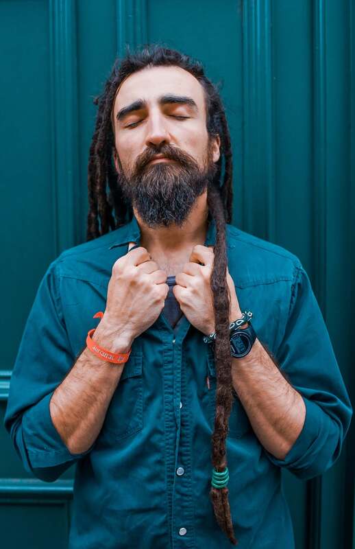 White man holding the collar of his shirt with his eyes closed. This represents the process of going within, accessing the inner observer, and healing our inner child.
