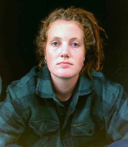 White woman looking into the camera, unsmiling. This represents the reality of difficult emotions. Sacred Circle Holistic Healing helps adults learn to navigate difficult emotions through therapy in Lawrence, Kansas.