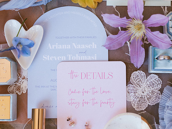 Light blue arch cut invitation with blue and white text; light pink details card with darker pink text & rounded corners