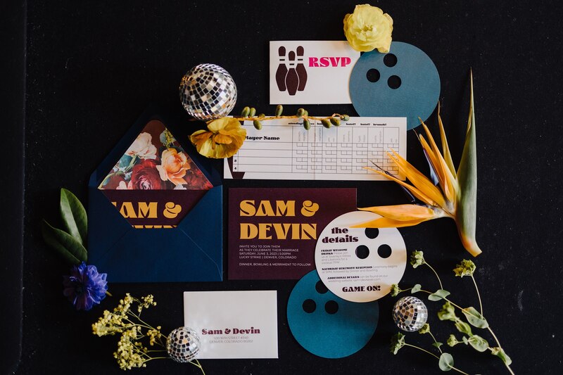 Dark burgundy invitation with mustard yellow text, Reply card cut to shape of bowling ball with finger holes, 