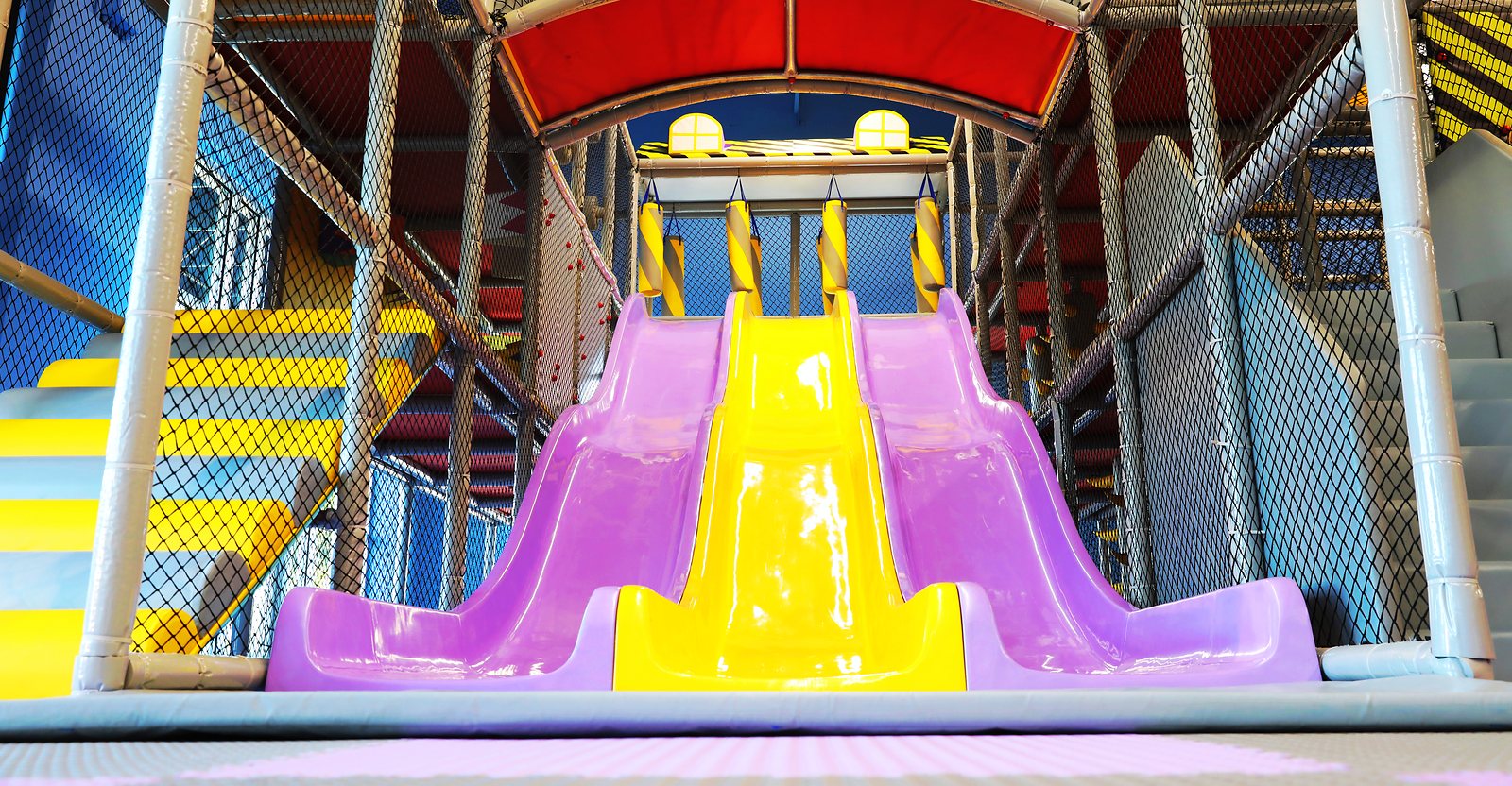 The purple and yellow slides inside Smarty Sprouts Kids’ Club.