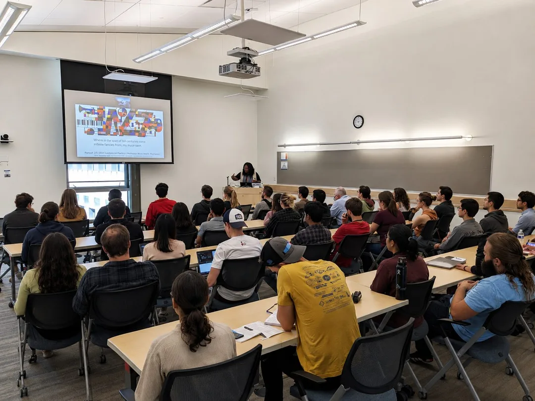Dr. LaNysha Adams speaking to a full lecture room at a national laboratory