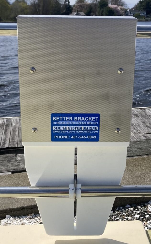 Outboard motor storage bracket on dock railing