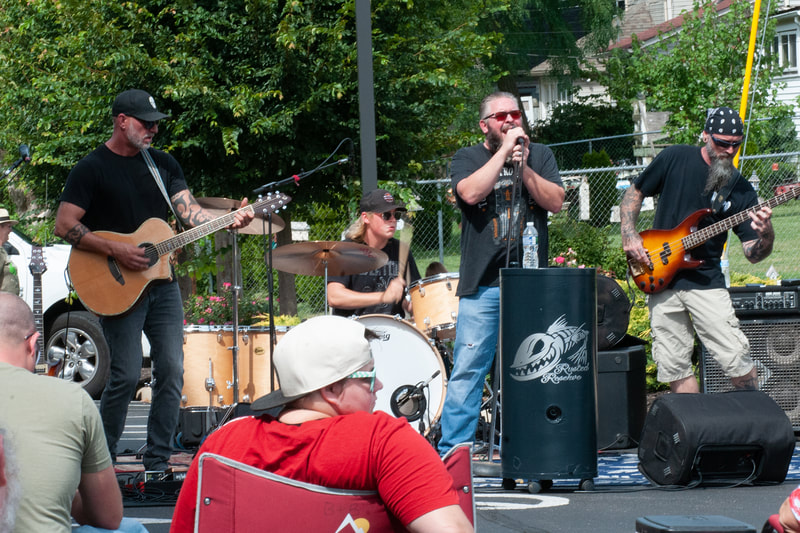 Rusted Reserve rocking out mid performance at porch fest in troy ohio