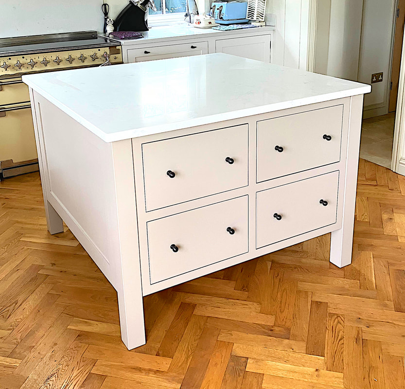 Elegant square kitchen island in Birdlip Gloucester with an integrated pull out bin and drawers