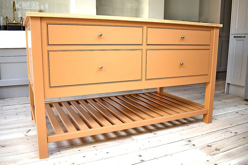 Beautifully proportioned kitchen island with quirk and bead framed drawer openings and pan shelf. Dulwich, London 