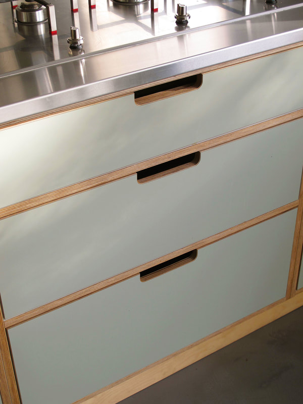 Contemporary formica laminated birch ply kitchen in Saffron Walden Esex with a stainless steel worktop