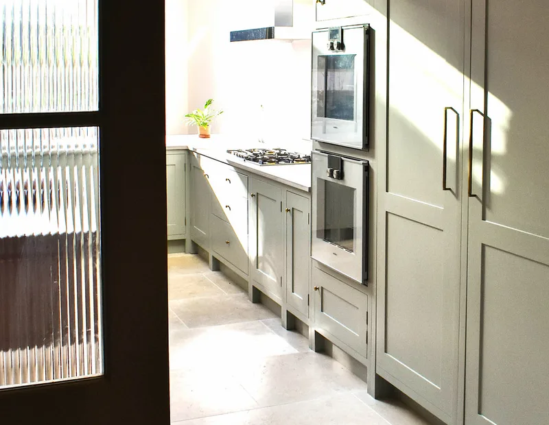Framed shaker kitchen in North London in North London seen through readed glass doors