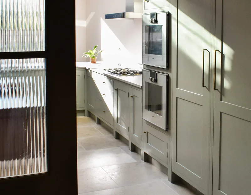 Framed shaker kitchen in North London in North London seen through readed glass doors