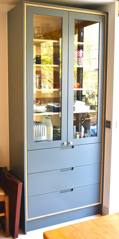 Sculpted pulls on contemporary glazed dresser North London