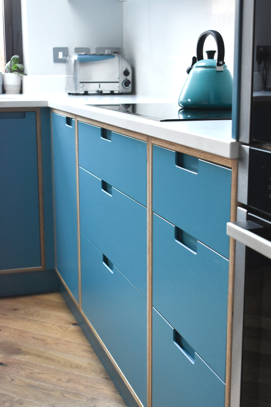 Sprayed contemporary handmade kitchen in Cround End North London. Birch ply drawers and doors