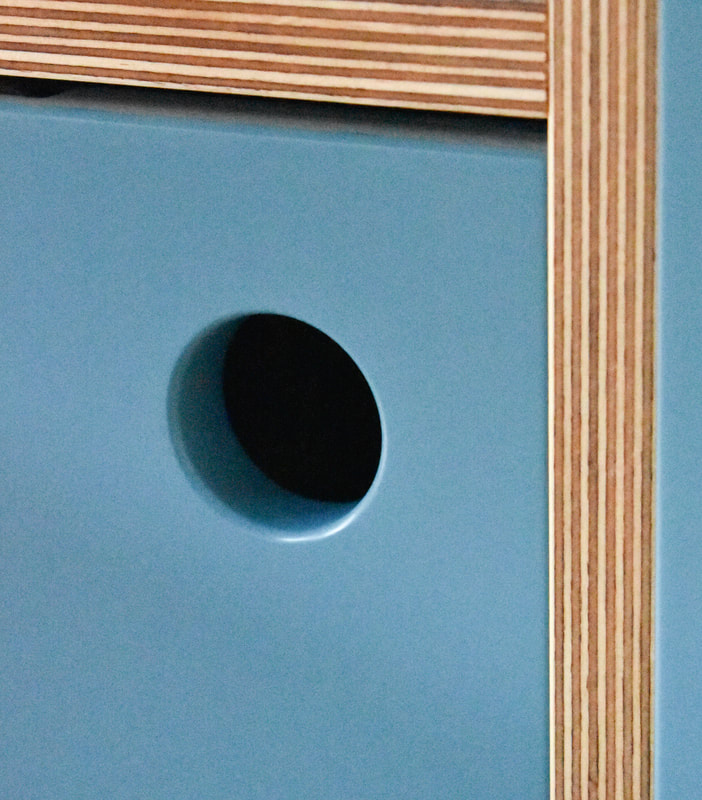 sprayed port hole opener  in sprayed contemporary handmade kitchen in Cround End North London. Birch ply drawers and doors