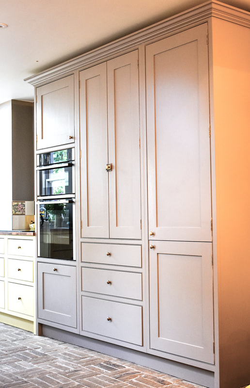 Tall handmade kitchen cabinets with larder in panelled shaker kitchen in Barnet North London