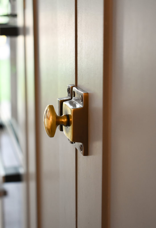 Beautiful antique brass catch on panelled shaker kitchen in Barnet North London