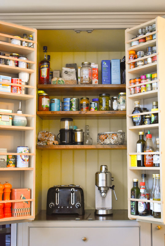 Reclaimed wood glazed cabinet in  handmade panelled shaker kitchen in Barnet North London