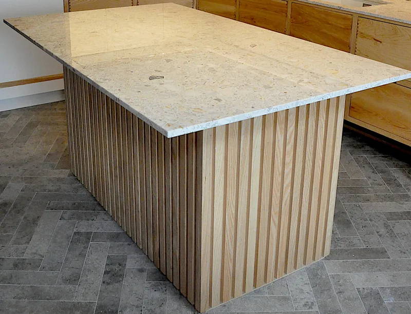 Solid ash kitchen in Dulwich London with dovetailed details on drawer fronts. Fluted ash kitchen island with birch ply drawers 