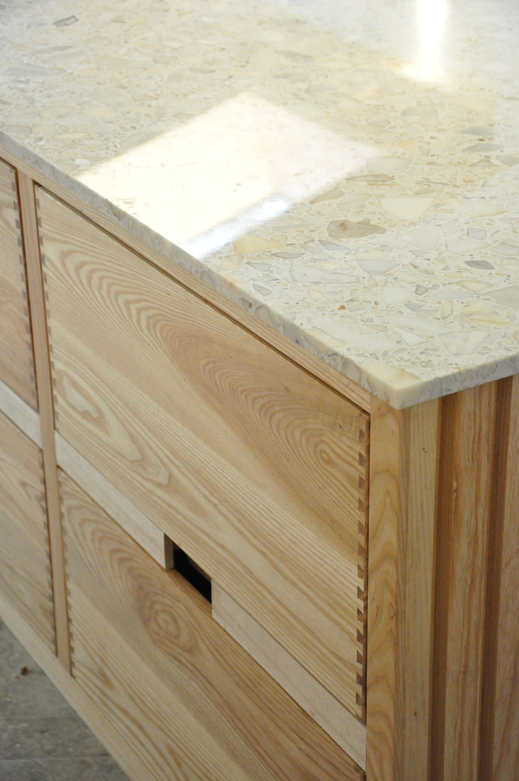 Solid ash kitchen in Dulwich London with dovetailed details on drawer fronts. Fluted ash kitchen island with birch ply drawers 
