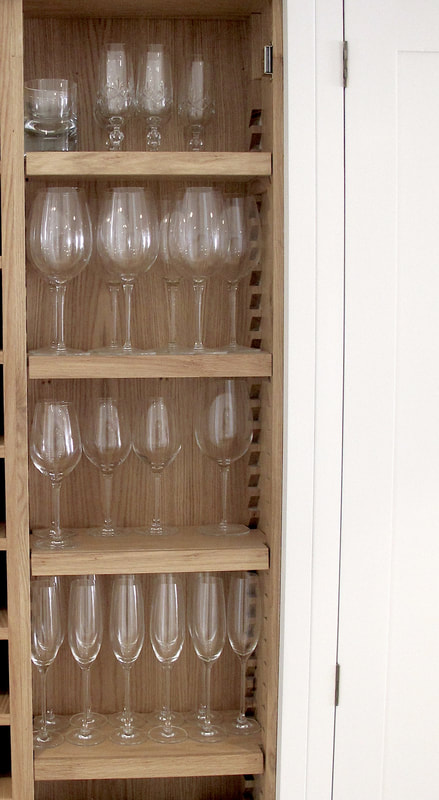 Glass cabinet in bespoke shaker framed kitchen in Islington North London. Soft close birch ply drawers. Hand painted solid timber kitchen island . 