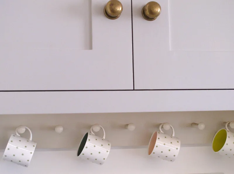 Traditional cup hooks in bespoke shaker framed kitchen in Islington North London. Soft close birch ply drawers. Hand painted solid timber kitchen island . 