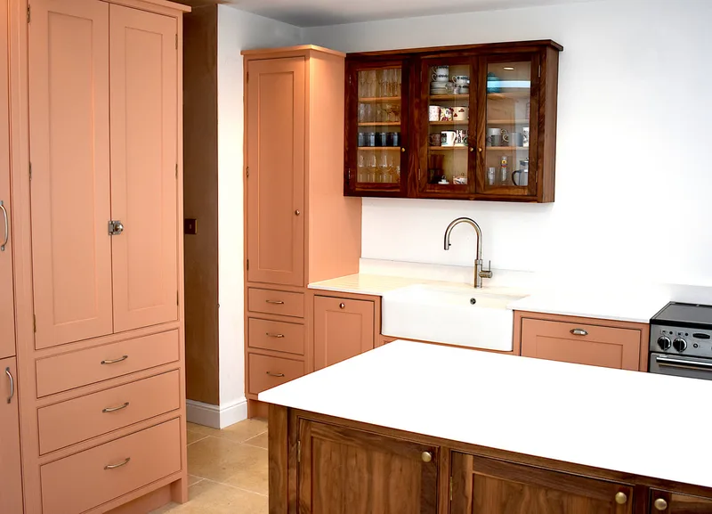 View of solid walnut island to shaker panelled doors behind
