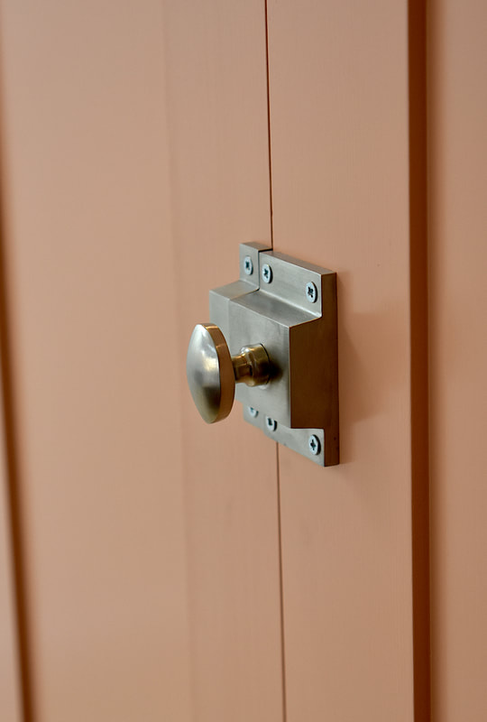 Elegant door catches on pantry doors in a kitchen on a modern shaker North London