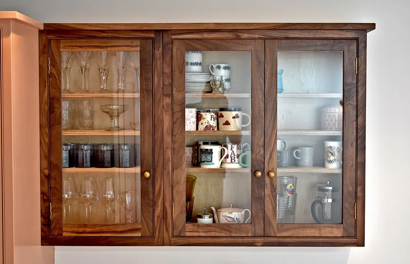 Glazed solid walnut cabinets in modern shaker kitchen London