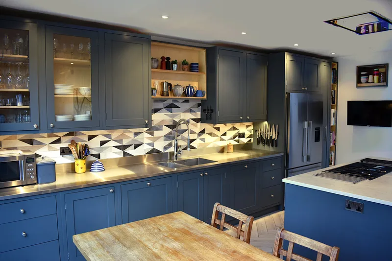 Contemporary mixed materials kitchen in Stroud Green North London finish sprayed with recessed drawer pulls and kitchen island with sliding doors 