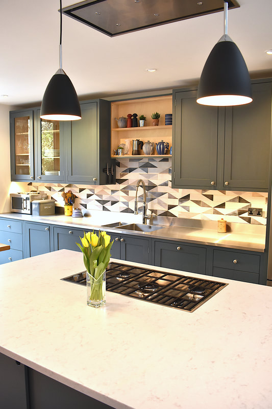 Contemporary mixed materials kitchen in Stroud Green North London finish sprayed with recessed drawer pulls and kitchen island with sliding doors 