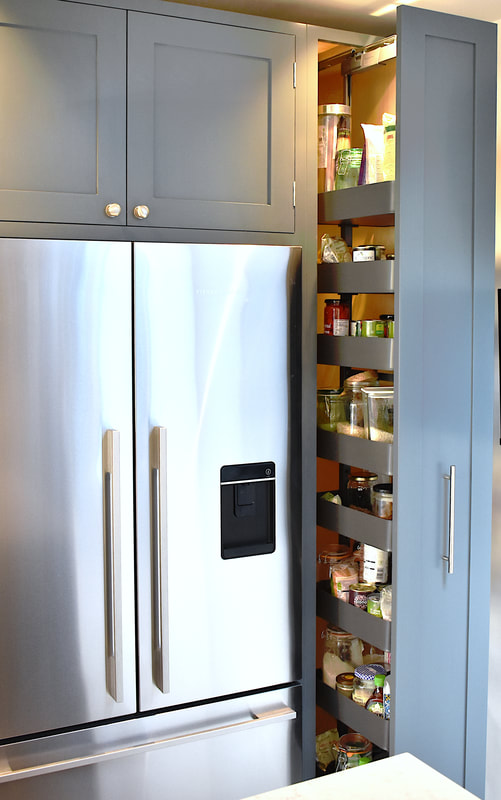 Contemporary mixed materials kitchen in Stroud Green North London finish sprayed with recessed drawer pulls and kitchen island with sliding doors 
