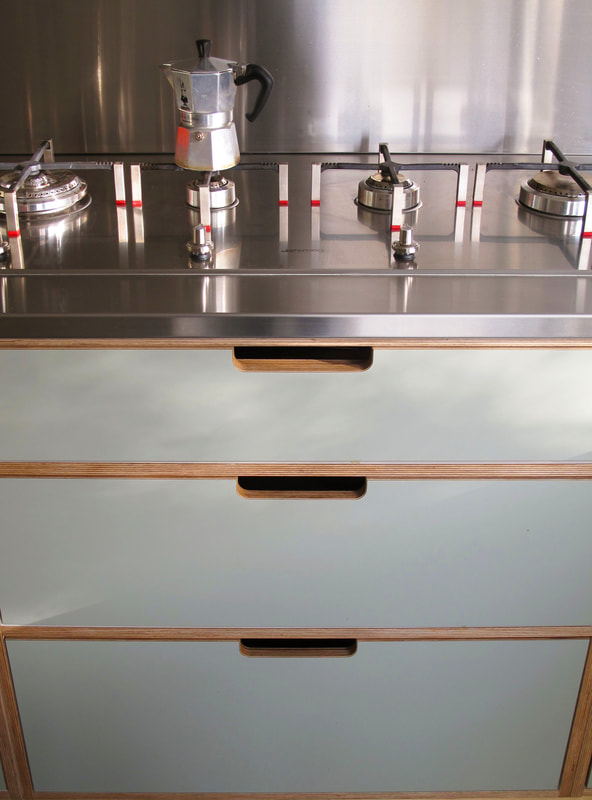 Contemporary formica laminated birch ply kitchen in Saffron Walden Esex with a stainless steel worktop