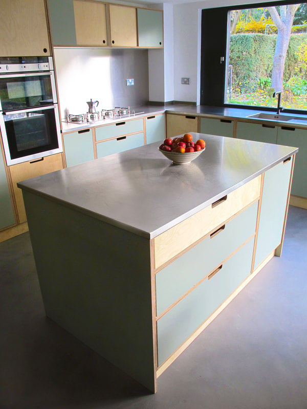 Contemporary formica laminated birch ply kitchen in Saffron Walden Esex with a stainless steel worktop