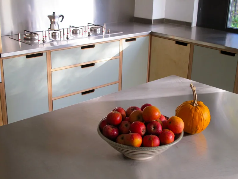 Contemporary formica laminated birch ply kitchen in Saffron Walden Esex with a stainless steel worktop
