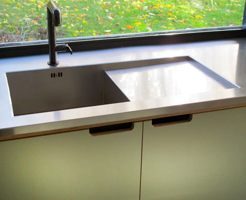 Contemporary formica laminated birch ply kitchen in Saffron Walden Esex with a stainless steel worktop