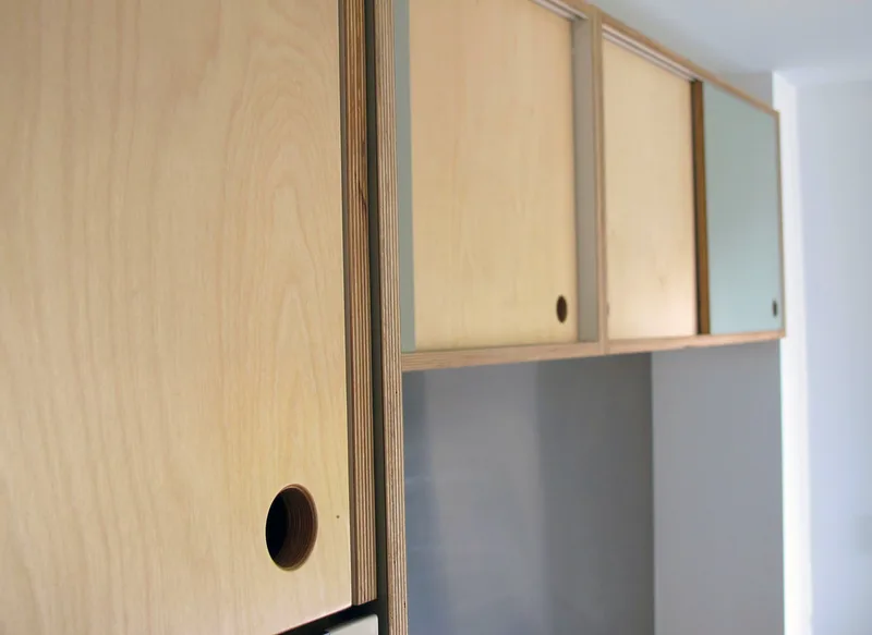 Contemporary formica laminated birch ply kitchen in Saffron Walden Esex with a stainless steel worktop