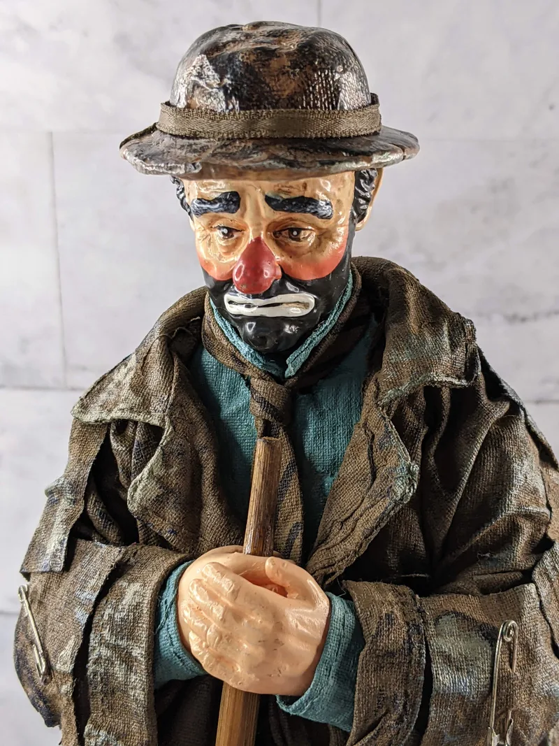 An Emmet Kelly Clown limited edition Spotlight figurine of a sad clown holding a broom.